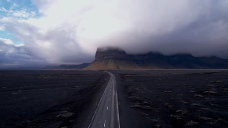 Secluded-Icelandic-Highway-with-Dramatic-cloud-cover-over-cliffs