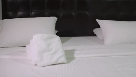 Hotel-Room-White-Bed-With-Pillow-AND-TOWELS-SLIDE-RIGHT-safe-strongbox,-comfort-concept
