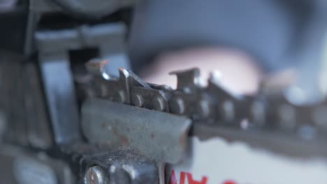 Using-file-to-sharpen-the-teeth-on-a-chainsaw-Close-up