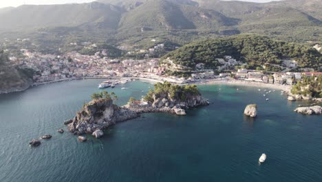 Aerial-dolly-over-scenic-bay-with-islets-in-Ionian-Sea-toward-seaside-town-Parga