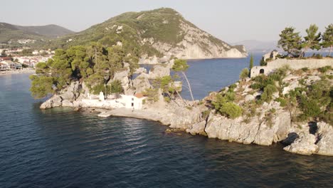 Rock-island-of-Panagia-just-off-Ionian-coastline-of-Parga,-Greece---aerial