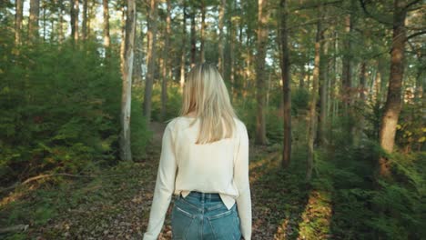 White-shirt-girl-walking-through-the-forest