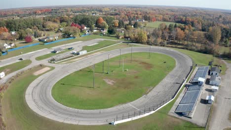 Whittemore-small-track-car-racing-Speedway-in-Whittmore-,-Michigan-with-drone-video-moving-up-at-an-angle