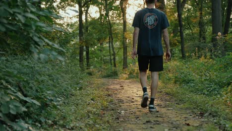 Young-Male-walking-through-woods-in-the-evening
