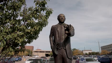Statue-of-auto-pioneer-Albert-Champion-in-Flint,-Michigan-with-gimbal-video-moving-forward