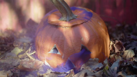 Rotten-halloween-jack-o'-lantern-with-a-thin-cloud-of-purple-smoke-drifting-out