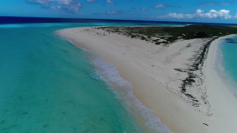 Amazing-drone-shot-caribbean-island-surrounded-by-turquoise-sea-water,-dolly-out