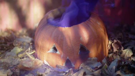 Rotten-Halloween-jack-o'-lantern-with-a-thick-cloud-of-purple-smoke-billowing-out-of-it