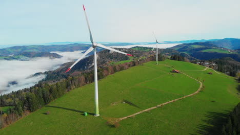 Two-spinning-wind-turbines-on-a-fall-afternoon-in-the-Swiss-jura-mountains-30fps-4k