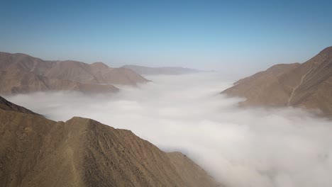 A-drone-shot-of-mountains-and-a-bed-of-clouds-in-the-valley-of-Santa-Eulalia-in-Peru
