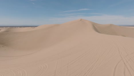 Flying-Over-Epic-Sand-Dune-Landscape-with-Blue-Skies,-Aerial-Drone-Footage-of-Soft-Sandy-Landscape-and-Vast-Expanse