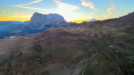 Mountains,-forest-and-grass-fields-with-wooden-cabins-filmed-at-Alpe-di-Siusi-in-Alps,-Italian-Dolomites-filmed-in-vibrant-colors-at-sunrise