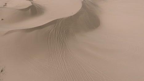 Soft-Sandy-Dunes,-Aerial-Drone-Shot-of-Bird-Flying-Over-Dune-Landscape-in-Southern-California-Desert