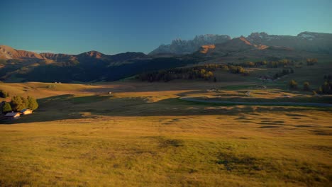 Mountains,-forest-and-grass-fields-filmed-at-Alpe-di-Siusi-in-Alps,-Italian-Dolomites-filmed-in-vibrant-colors-at-sunset