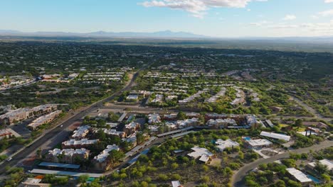 Flying-over-Tucson-Arizona-on-Sunny-Day,-Neighborhood-of-Catalina-Foothills-Below-and-Bright-Sky-Ahead