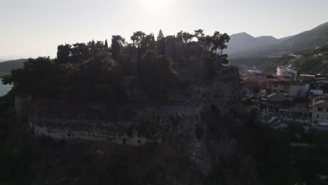 Medieval-hilltop-citadel-complex-Parga-Castle-in-town-Parga,-Greece,-pull-away-aerial