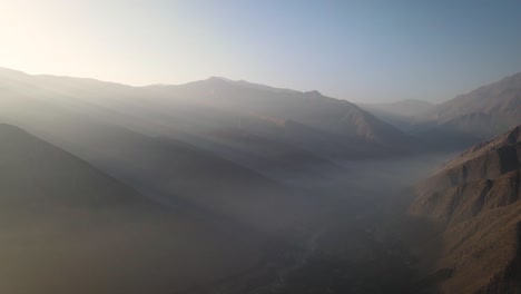 Light-beams-shot-with-a-drone-in-the-misty-mountains-of-Lima-Peru