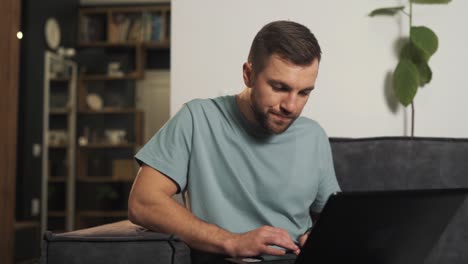 Concentrated-man-carefully-reviews-information-on-a-laptop