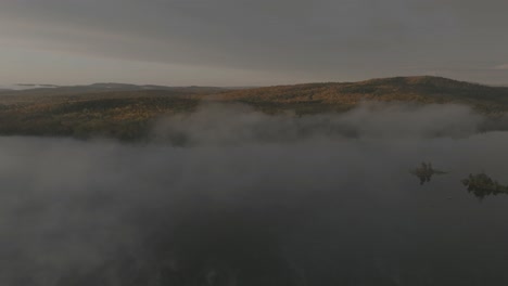 Lake-Onawa-orbiting-aerial-reveals-Borestone-Mountain-through-lifting-fog