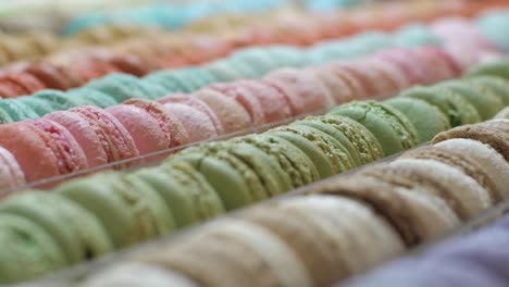 Looking-at-delicious-colorful-macaroons-in-rows---Close-up