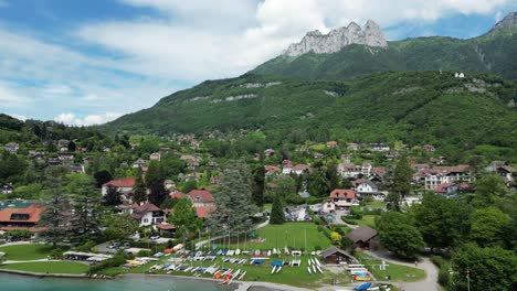 Talloires-Beach-at-Turquoise-Lake-Annecy-in-French-Alps---Aerial-Pedestal-Up