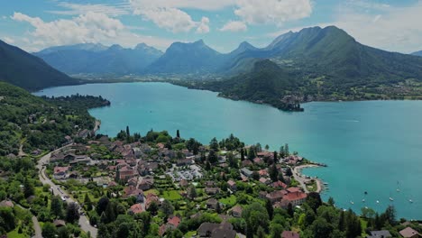 Blue-Lake-Annecy,-Green-Mountains-and-Talloires-Cityscape-in-French-Alps---Aerial