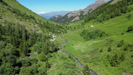 Small-Floating-River-in-Green-Valley-in-French-Alps---Aerial