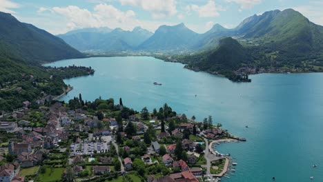 Lake-Annecy-Ferry-and-Talloires-Cityscape-in-French-Alps---Aerial