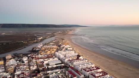 Aerial-shot-of-waves-crashing-onto-a-beach-in-Barbate,-Spain