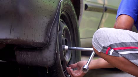 Slow-Motion---CLose-up-shot-of-a-man-loosen-tire-nuts-to-change-tires