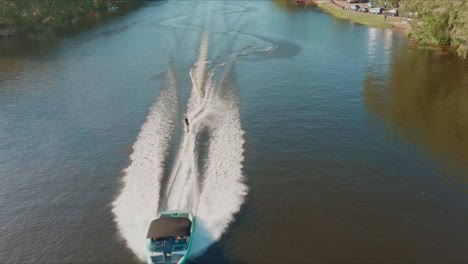 Aerial-view-of-riding-speedboat-and-waterski-on-waters