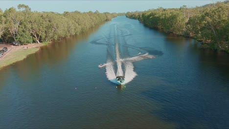Aerial-shot-of-Wakeboarder-Towing-Boat-on-the-river