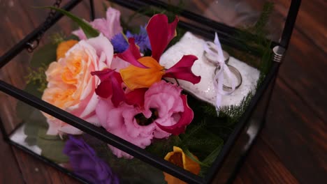 Open-See-Through-Box-With-Flowers-And-Wedding-Rings