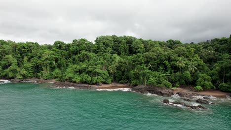 Tropical-beach-with-palm-trees-on-rainforest-coastline-of-Costa-Rica