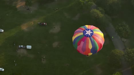 Hot-air-balloon-rising-above-a-park-in-Boise,-Idaho-during-summer-time