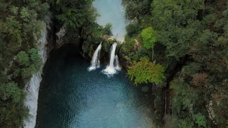Waterfalls-pouring-into-canyon-river-in-Plitvice-lakes,-Croatia,-drone