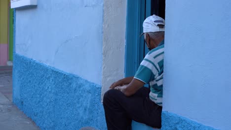An-old-man-sitting-by-his-house-on-this-beautiful-island-in-Guatemala,-Flores