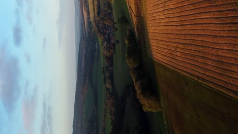 Vertical-cinematic-establishing-shot-England-fields-and-beautiful-sky