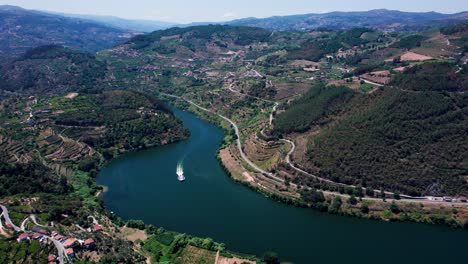 Douro-river-valley-with-cruising-ship-and-towns-on-hilly-shorelines