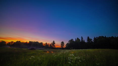 Stunning-sunset-then-bonfires-as-people-enjoy-a-night-in-the-countryside---all-night-and-day-time-lapse
