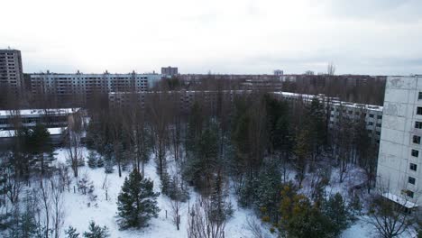 Flyover-above-Pripyat-evacuated-city-near-Chernobyl-in-winter-snow