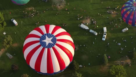 Top-down-aerial-view-of-a-hot-air-balloon-rising-above-the-Spirit-of-Boise-festival