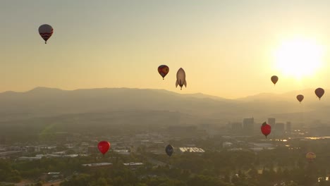 Silhouettes-of-of-hot-air-balloons-floating-through-a-smoke-filled-valley
