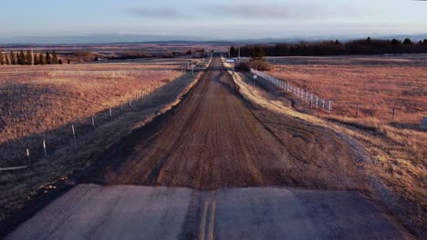 Country-dirt-road-in-the-evening-with-mountains-in-the-distance-Alberta-prarie