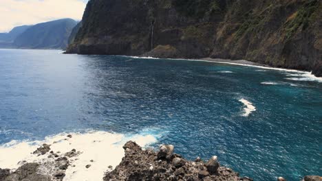 Rock-isle-reef-with-cave-near-steep-ocean-coast-cliffs-of-Madeira