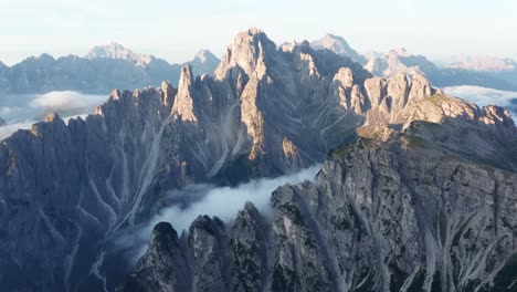 White-Clouds-below-rugged-Dolomites-mountain,-Cadini-Di-Misurina-during-sunrise