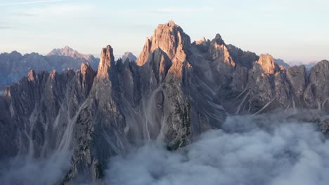 First-rays-of-sunrise-catch-jagged-peaks-of-Cadini-di-Misurina,-Dolomites