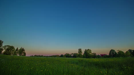 Dawn-To-Dusk-Timelapse-Over-Green-Field-With-Rising-And-Setting-Sun-With-Rolling-Clouds