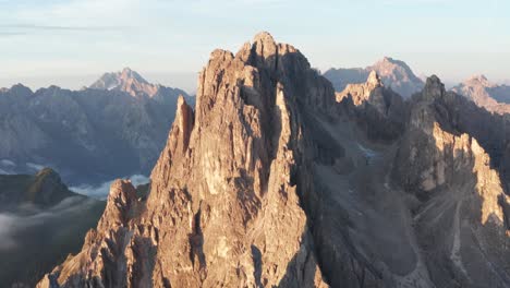 Close-drone-view-as-first-rays-of-sunrise-hit-peaks-of-Cadini-di-Misurina,-Italy