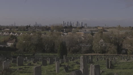 UK-Financial-District-Looms-on-Horizon-with-Cemetery-with-Gravestones-in-the-Foreground